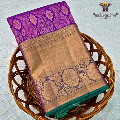 A Royal purple with a teal green border accent and rich gold zari Saree