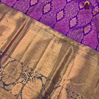 A Royal purple with a teal green border accent and rich gold zari Saree