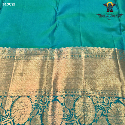 A Royal purple with a teal green border accent and rich gold zari Saree