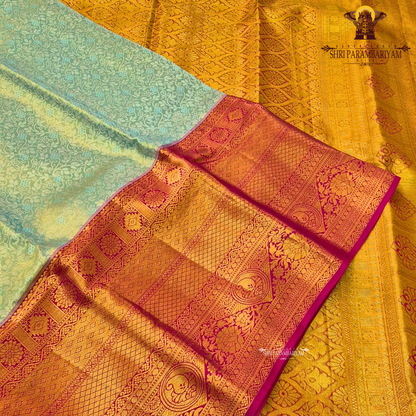 A soft ivory / off-white tissue base with rich antique gold zari work Saree