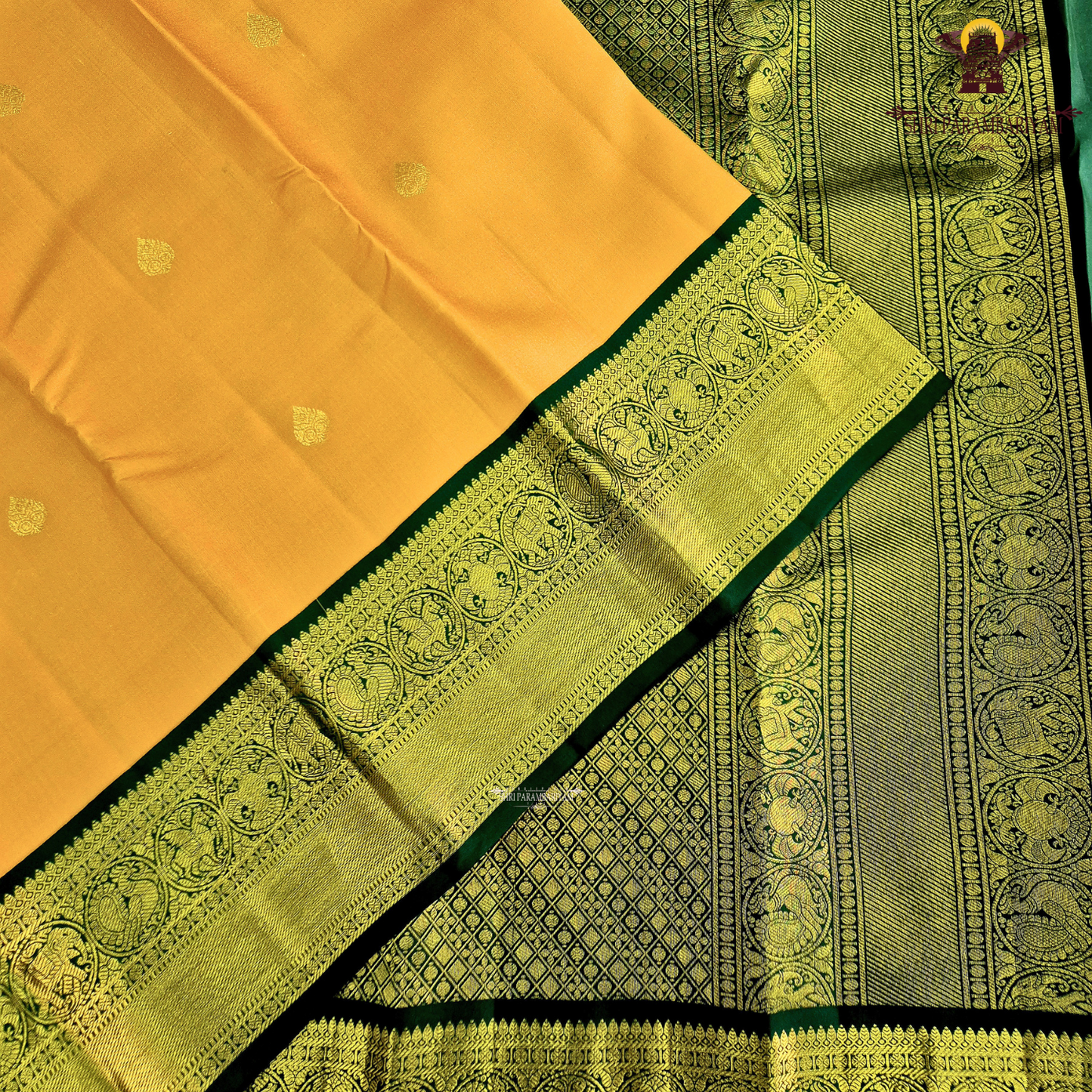 A vibrant mustard orange body highlighted with delicate zari buttas Saree