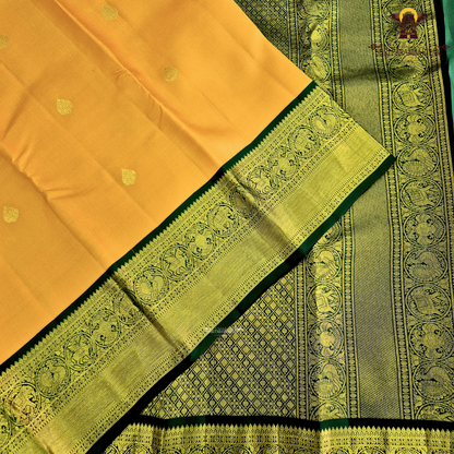 A vibrant mustard orange body highlighted with delicate zari buttas Saree