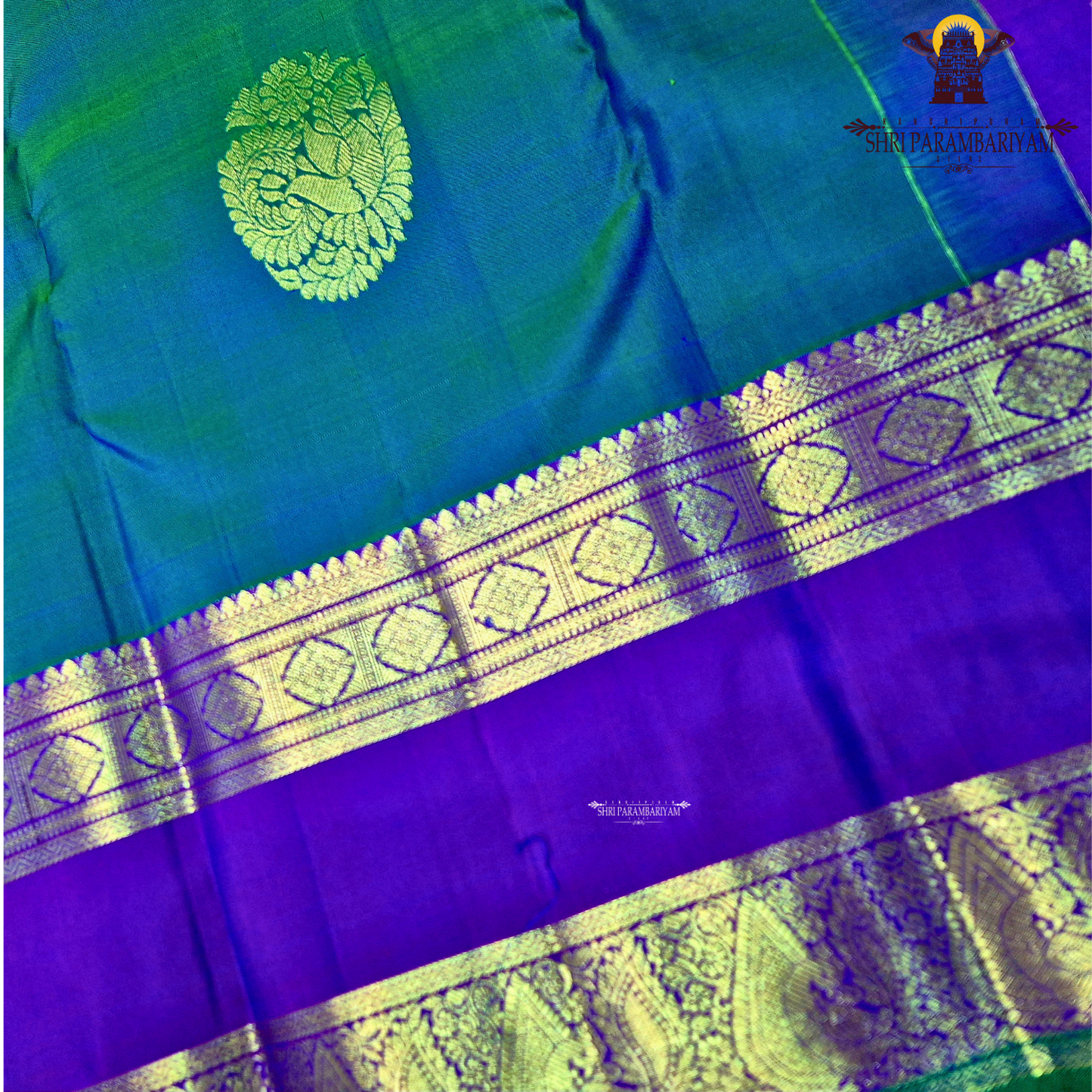 A elegant teal blue (peacock blue) body with a rich contrast purple/violet border Saree