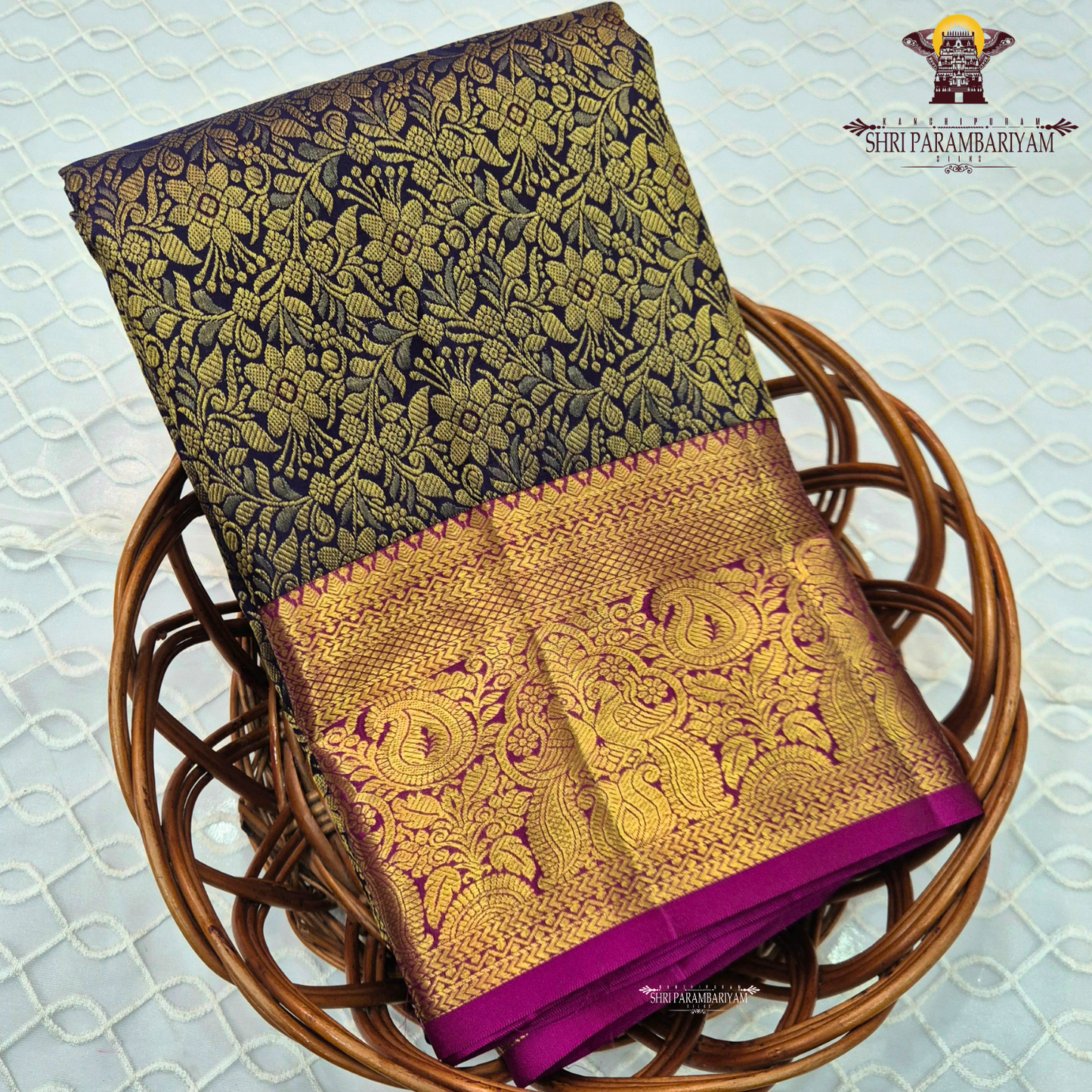 A rich black (or very deep navy) body with an opulent antique gold zari weave, paired with a contrasting rani pink Saree