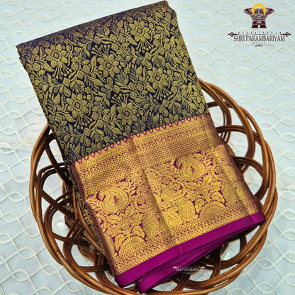 A rich black (or very deep navy) body with an opulent antique gold zari weave, paired with a contrasting rani pink Saree