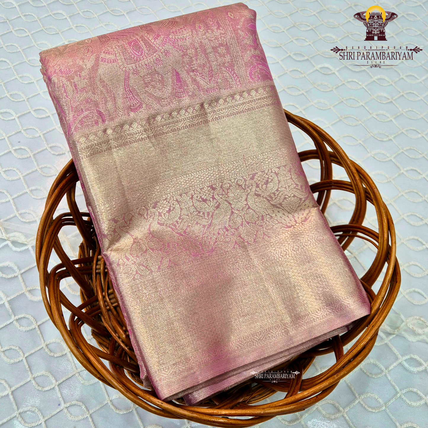 A graceful rose pink shade blended with antique gold tissue weaving Saree