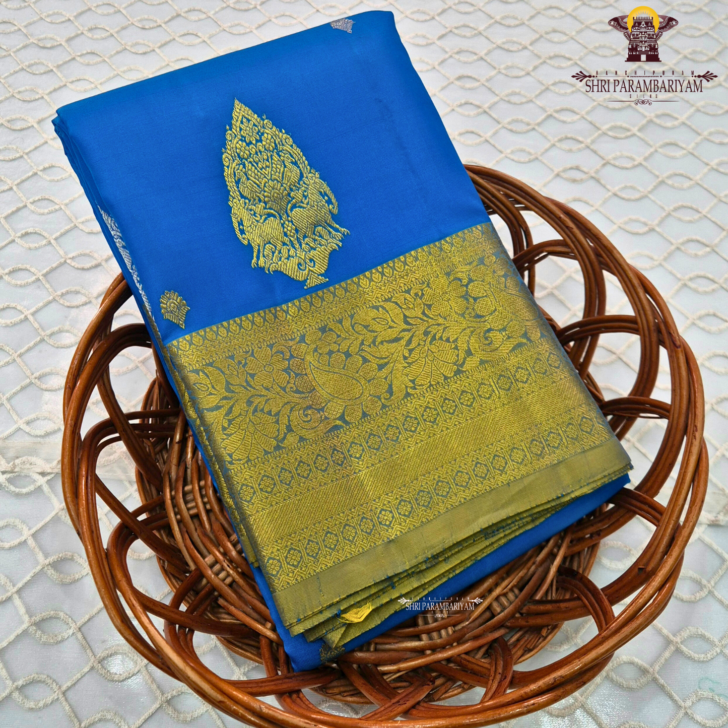 Vibrant royal blue with a rich gold zari border featuring a subtle green undertone Saree