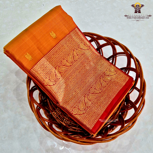 A golden Orange / Mango Orange with Rich Red and Gold Zari Border Saree
