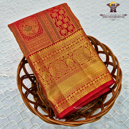Bright vermilion red with rich antique gold zari accents Saree