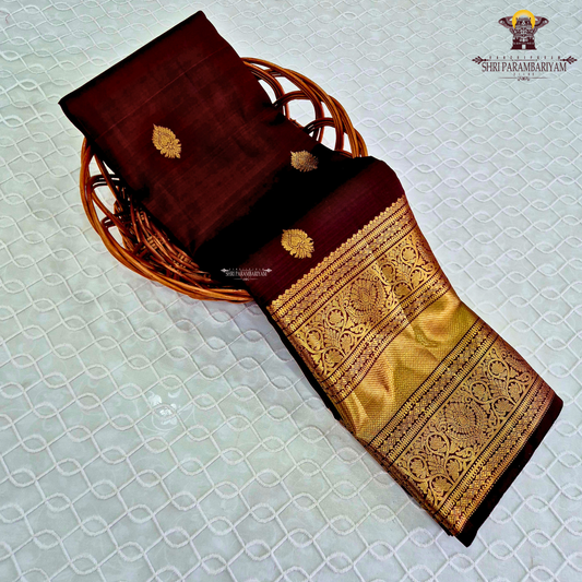 A rich wine maroon body with elegant gold zari butta Saree