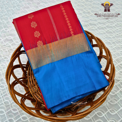 A vibrant deep red body paired with a contrasting Saree