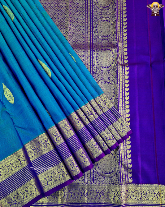 A rich royal blue body with a deep violet (purple) contrast border Saree